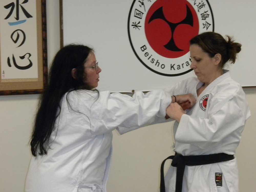 instructor and student in karate class for adults